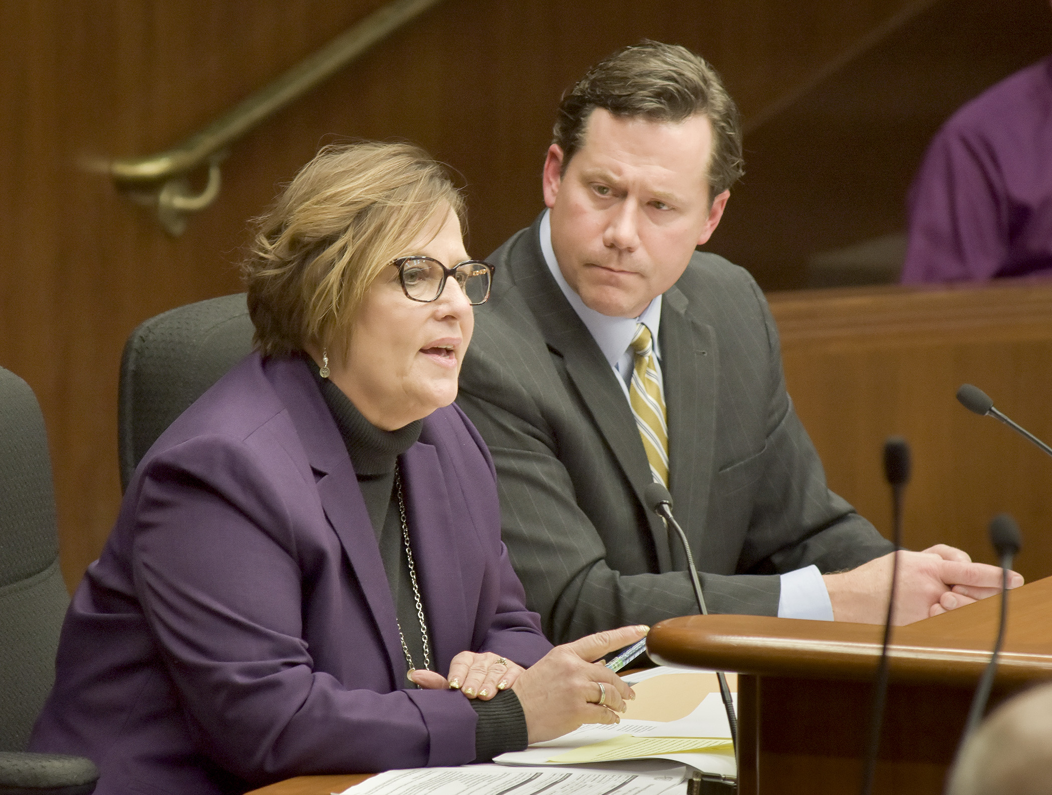 Dawn Olson, director of the Driver and Vehicle Services Division of the Public Safety Department, testifies before the House Civil Law and Data Practices Policy Committee Jan. 10 in support of a bill sponsored by Rep. Dennis Smith, right, that would authorize implementation of the REAL ID Act and amend state driver’s license and identification card requirements. Photo by Andrew VonBank